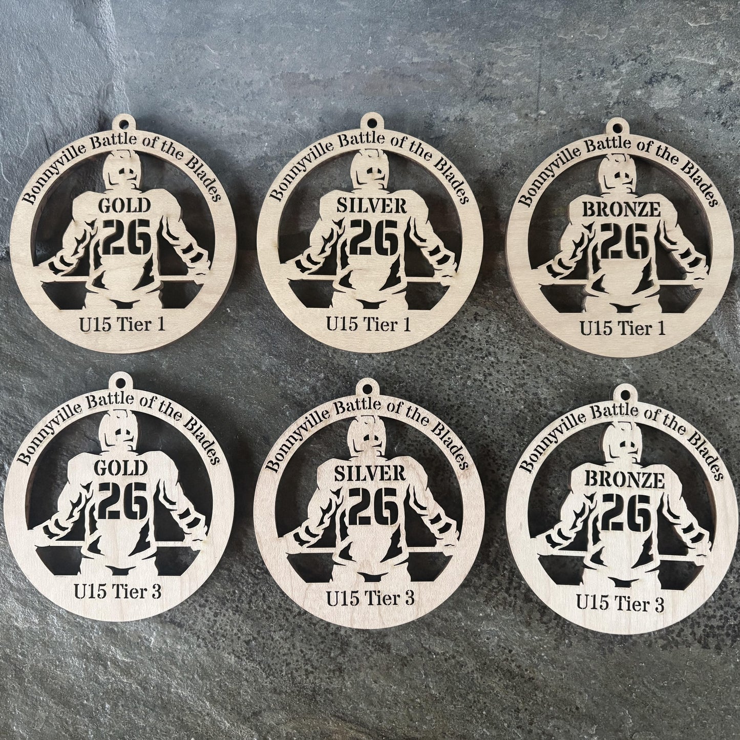 Custom laser-cut wooden hockey medals – Bonnyville tournament | Ornemoi
